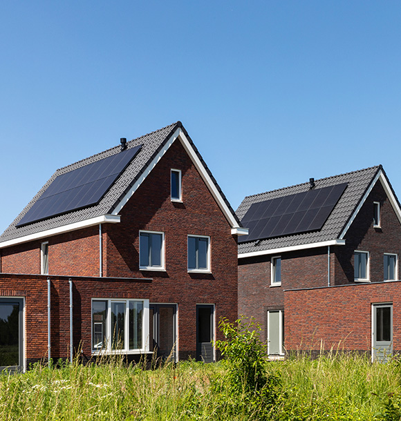 two houses with solar panels installed on to their roofs